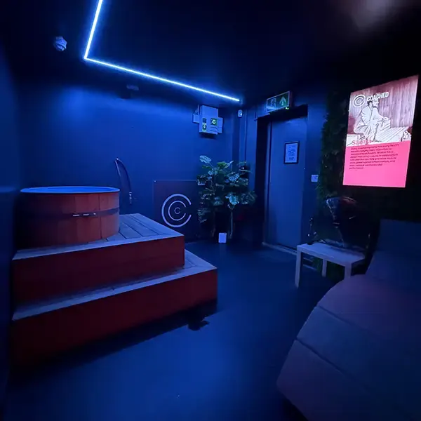 Contrast therapy suite with cold plunge tub under blue LED lighting