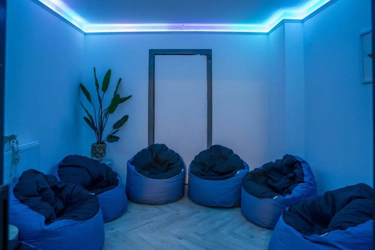 Blue-lit relaxation room with bean bags