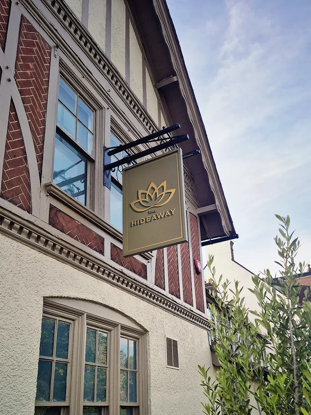 Hideaway sign on the Tudor-style building exterior