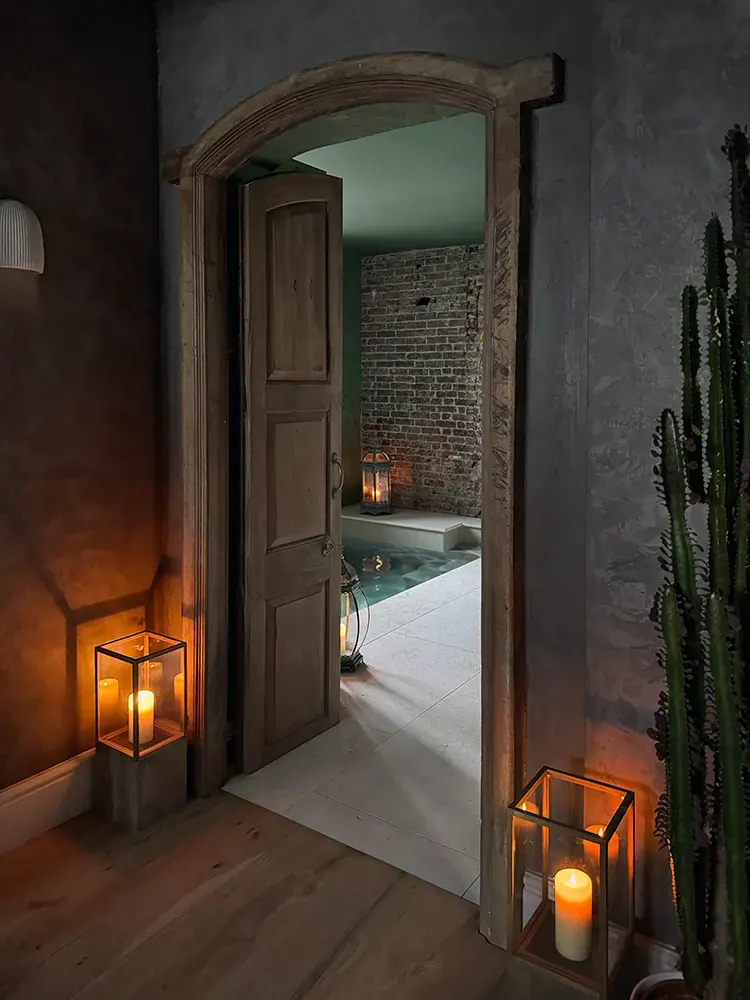Candlelit archway opening onto the spa pool room