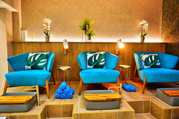 Relaxation area with turquoise chairs and pedicure basins
