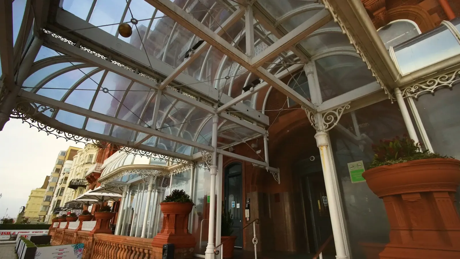 Glass canopy entrance of the Metropole hotel on the seafront