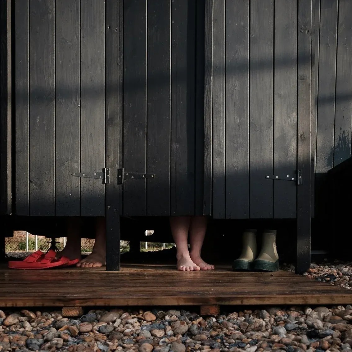 Wooden changing cubicles on the shingle