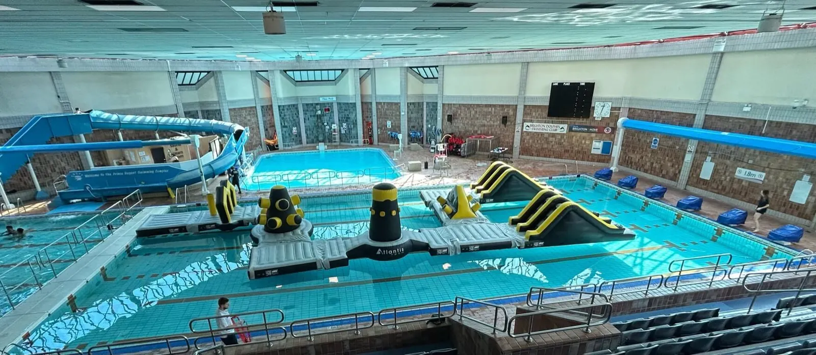 Panoramic view of the pool hall with inflatables and a slide
