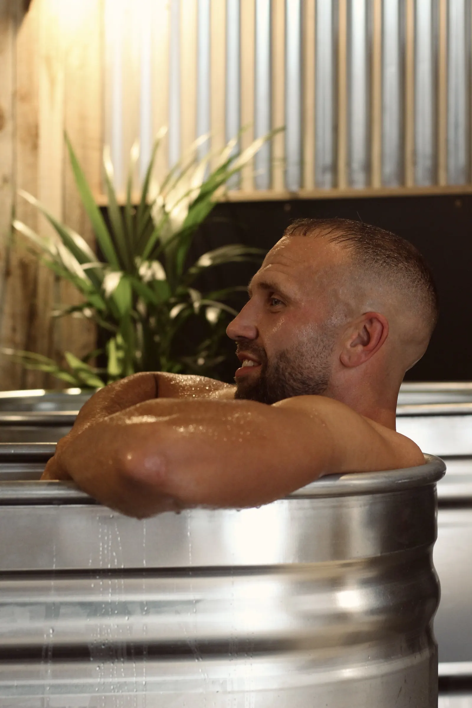 Man in a steel cold plunge tub