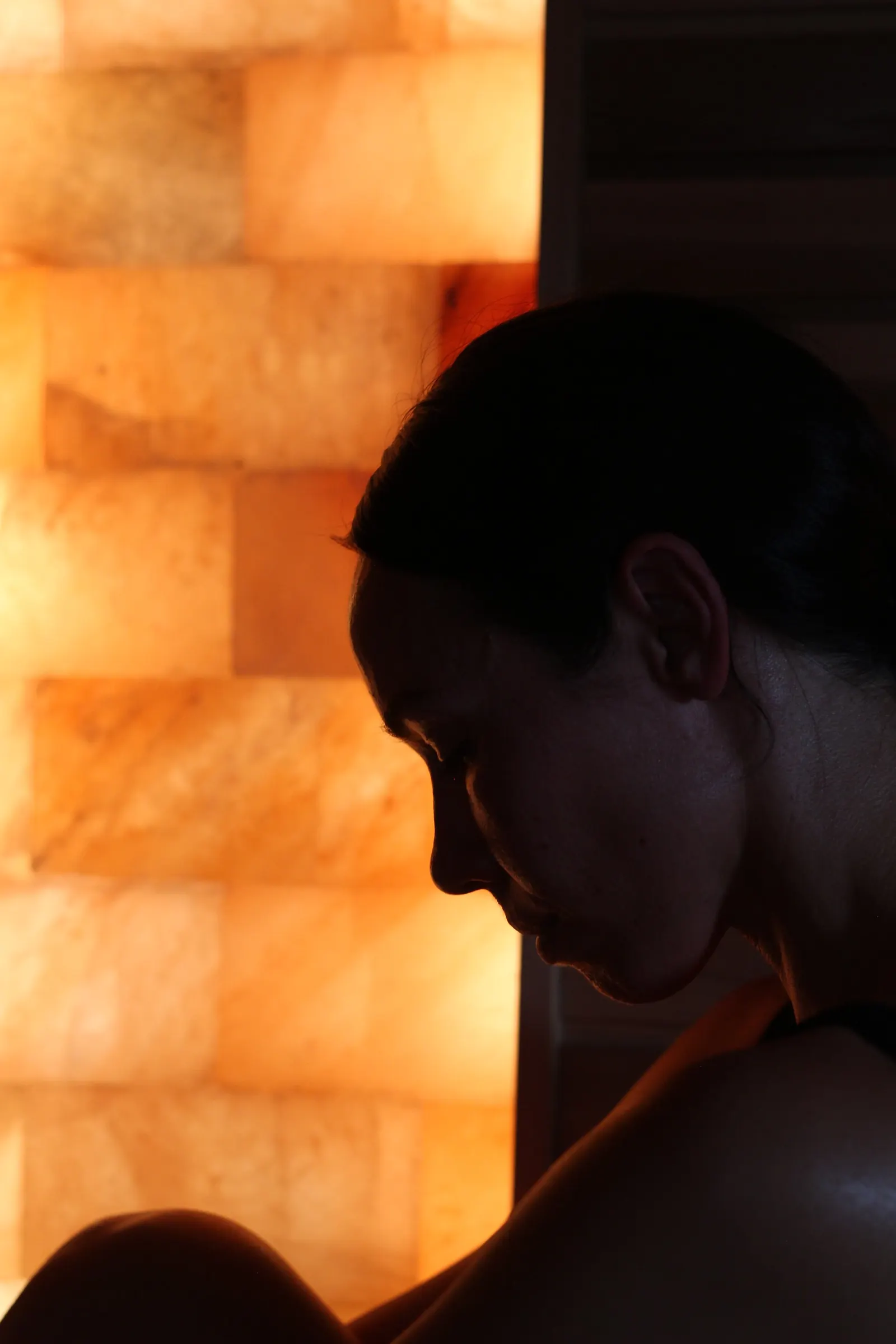 Guest in silhouette against the glowing salt wall