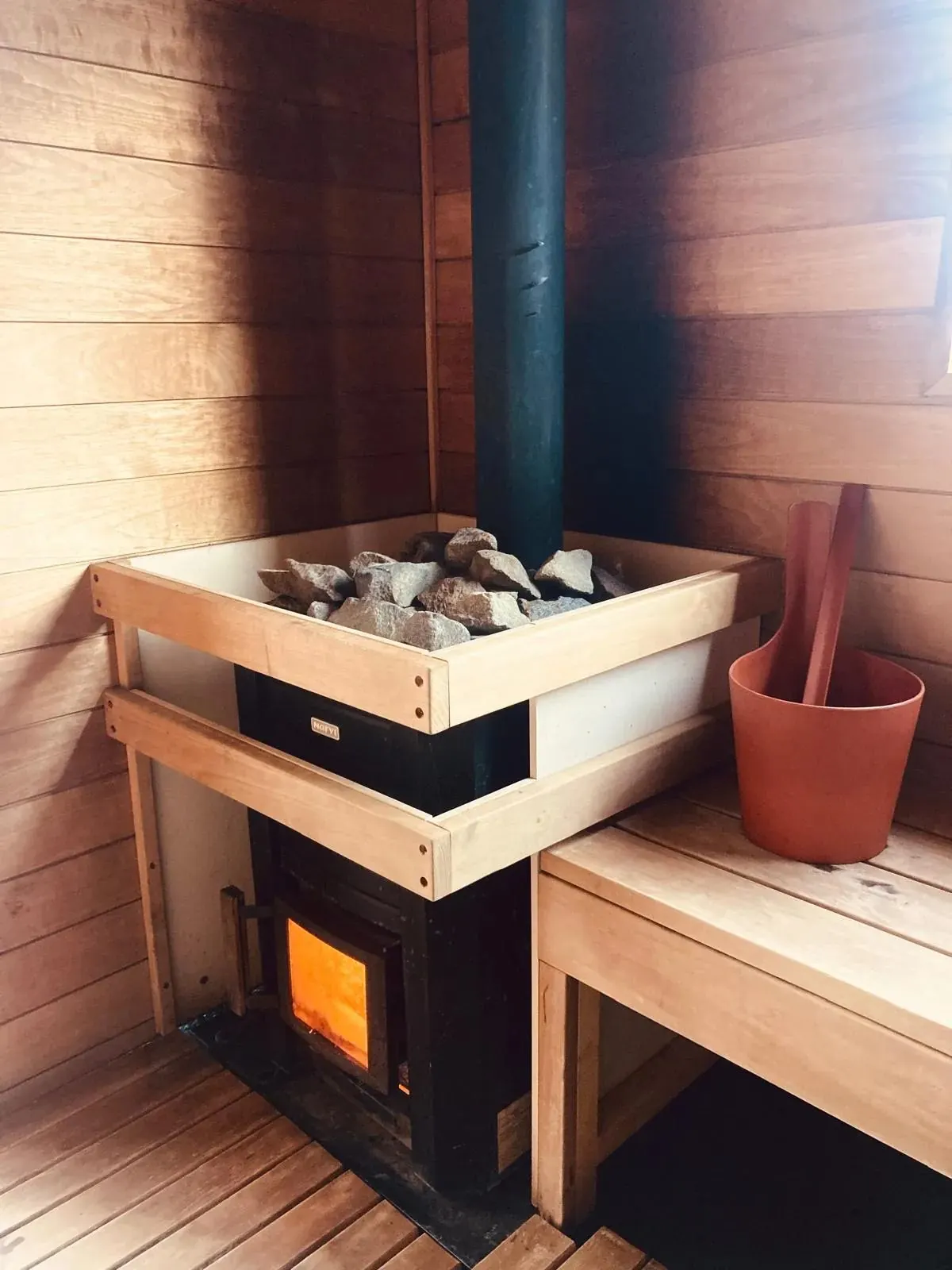 Wood-fired stove inside the sauna
