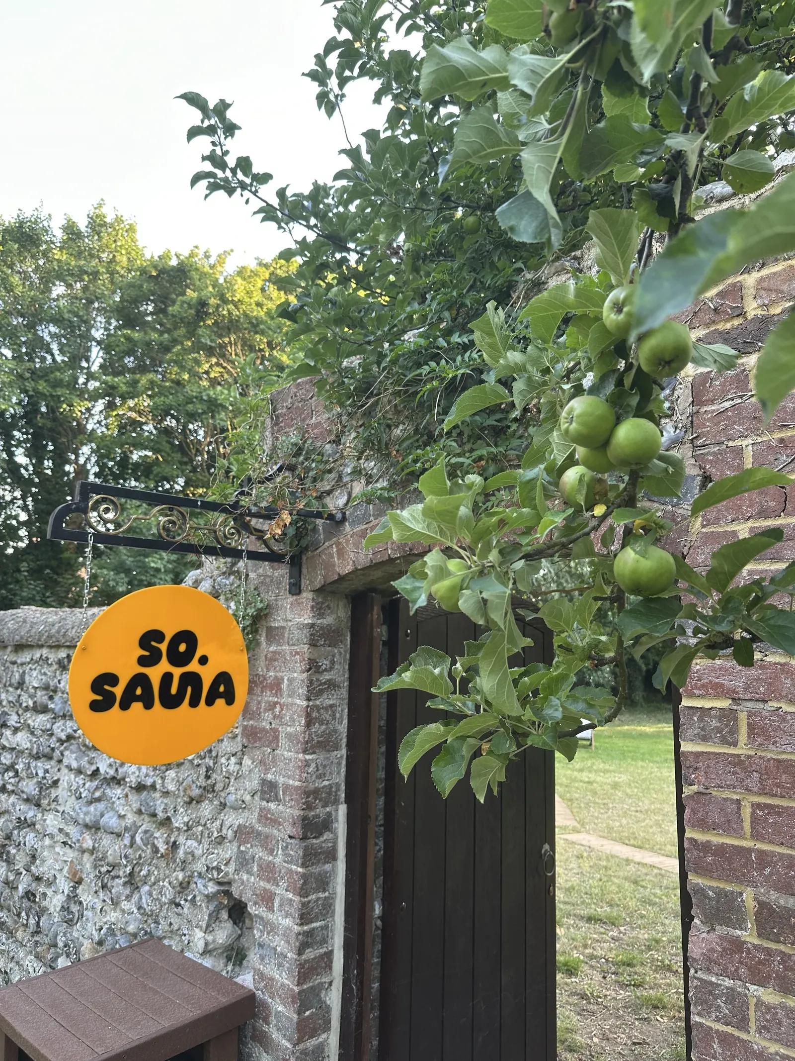 Garden gate with the so.sauna sign at Hangleton Manor