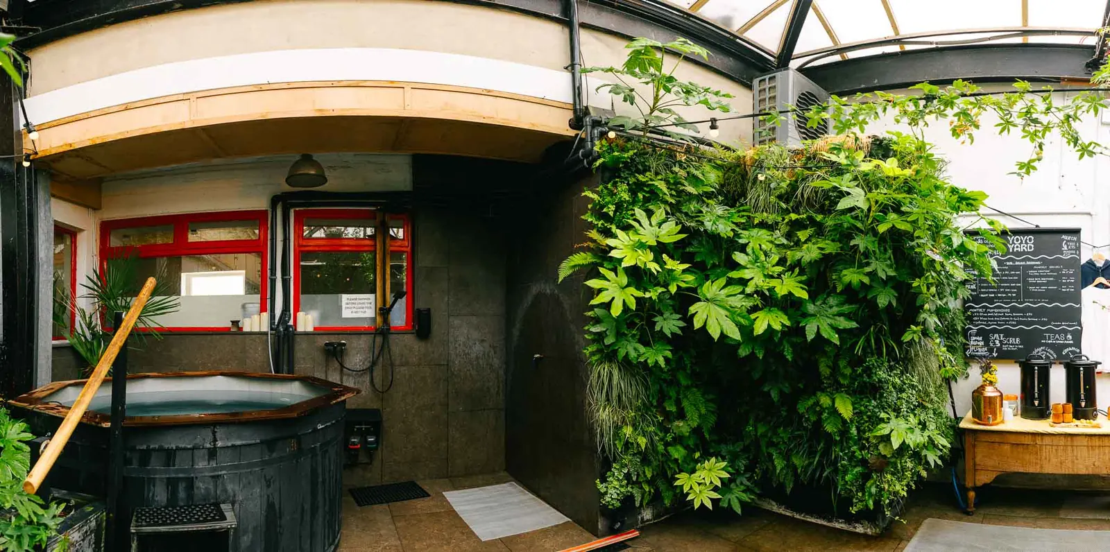 Wood-fired hot tub and leafy terrace