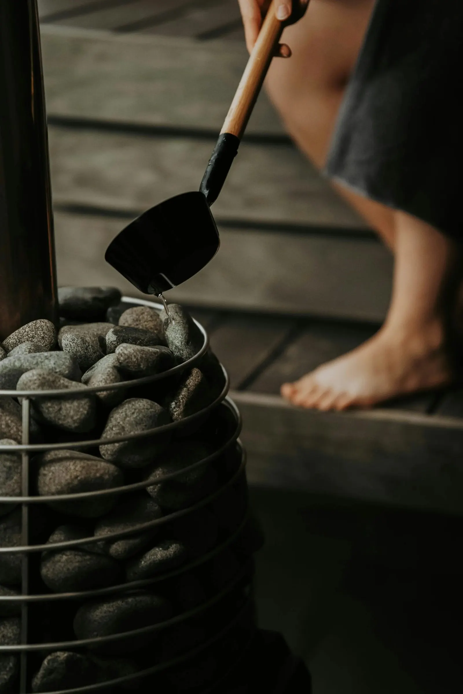 Ladling water onto sauna stones